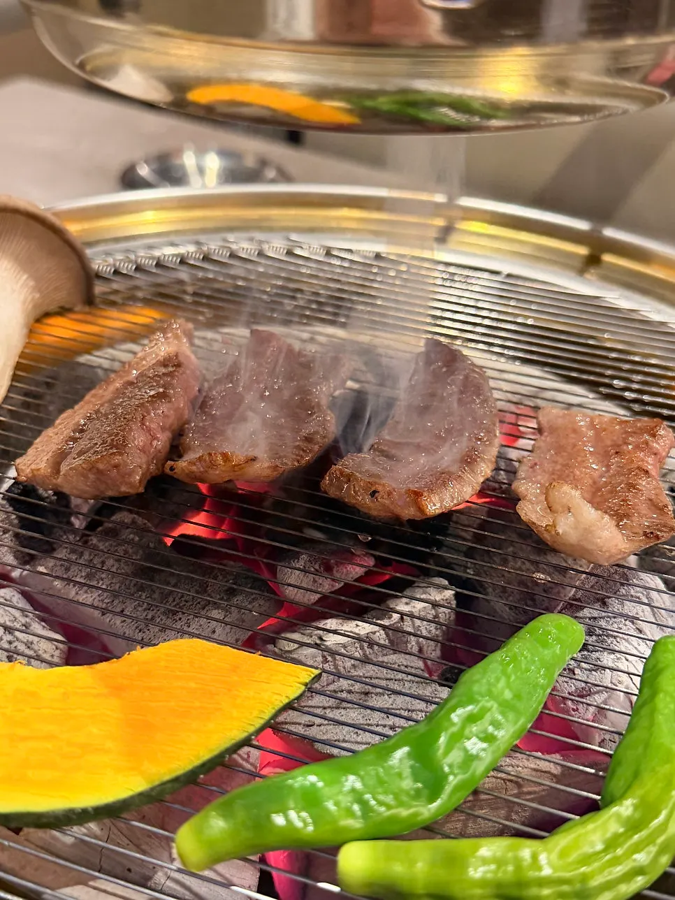 Hanwoo brisket getting a charcoal aroma on the grill
