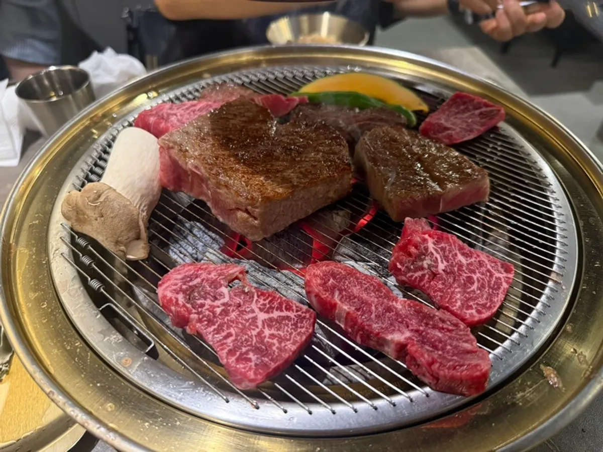 A well-cooked piece of hanwoo ready to dip in salt