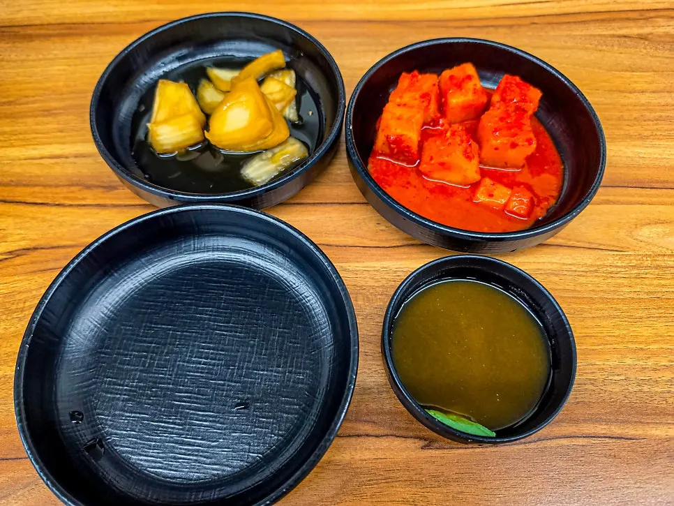 Basic side dish spread with kkakdugi and meat dipping sauce