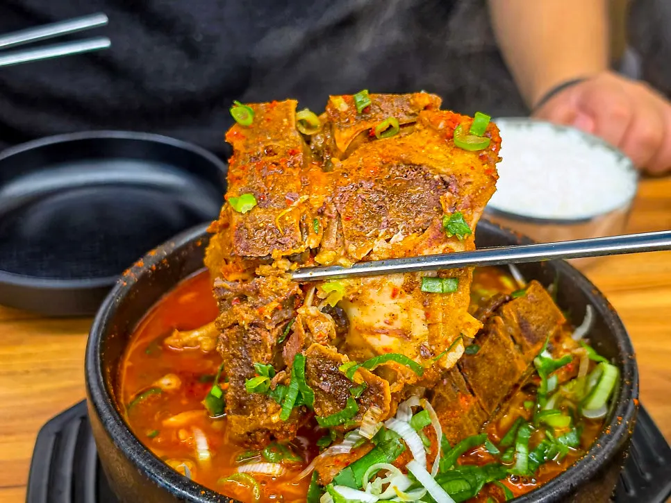 Meat picked off the bone and placed on top of rice