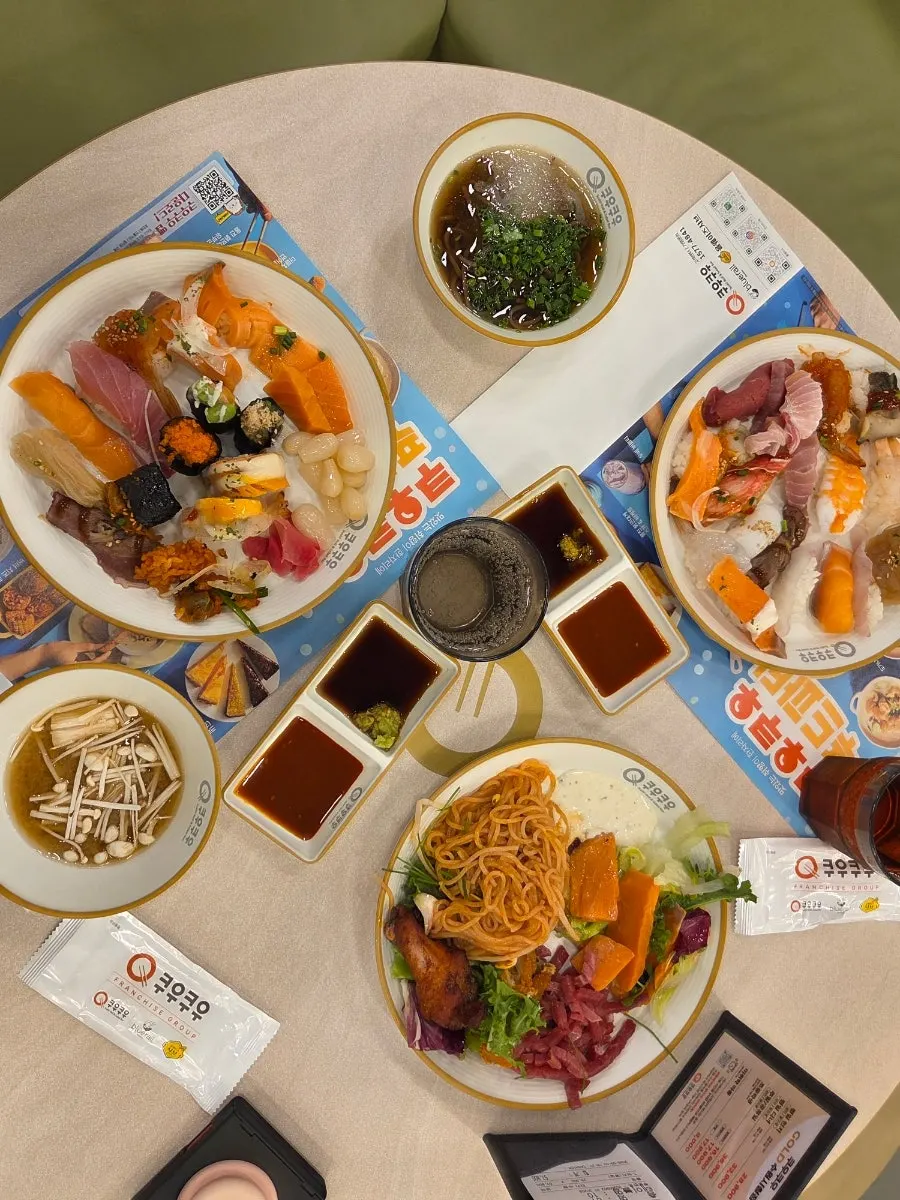 Table spread with sushi and grilled dishes