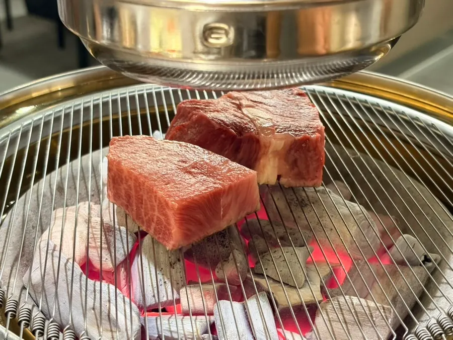 Hanwoo sirloin browning nicely over the charcoal