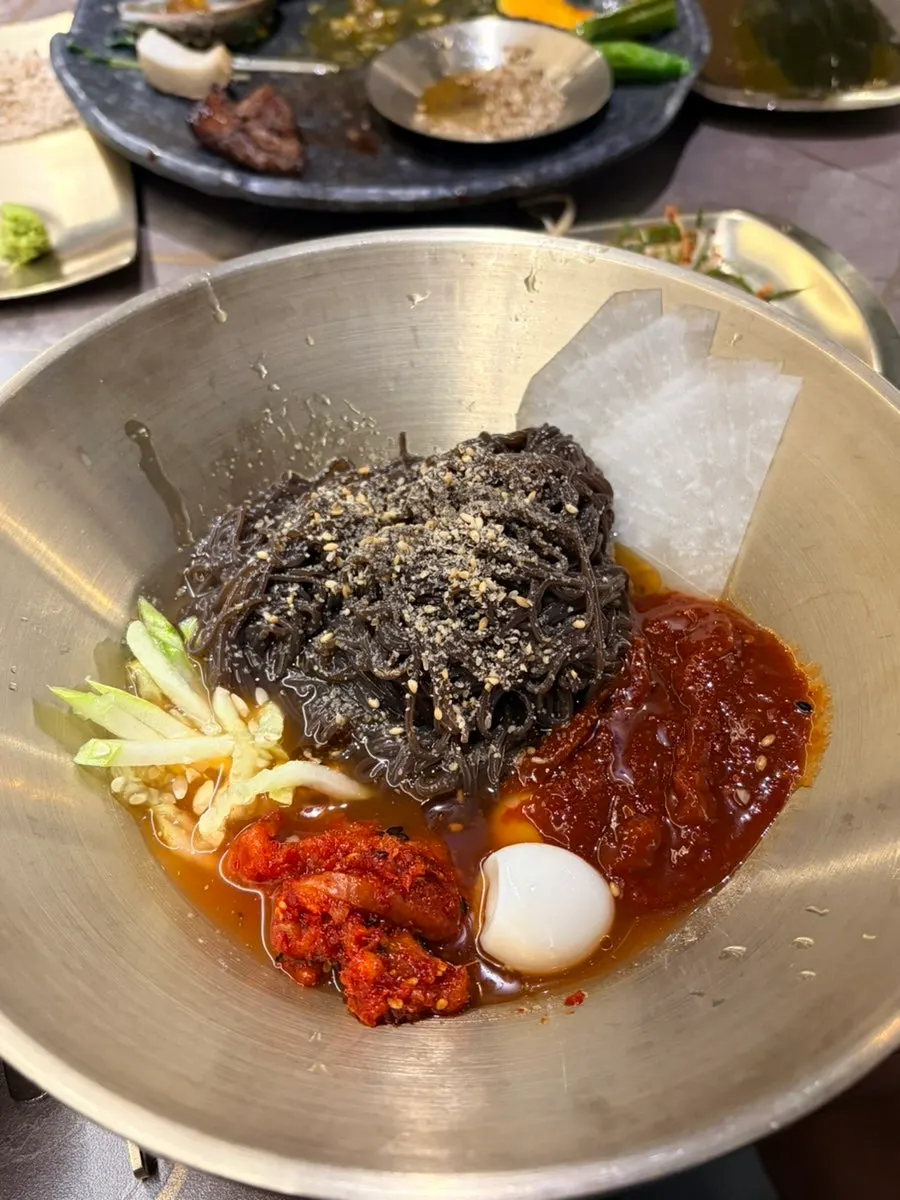 Bibim naengmyeon topped generously with garnish