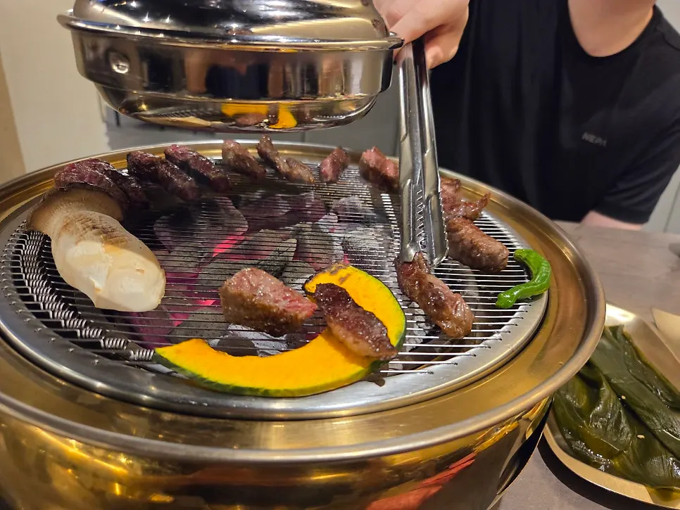 Hanwoo grilling over a charcoal brazier