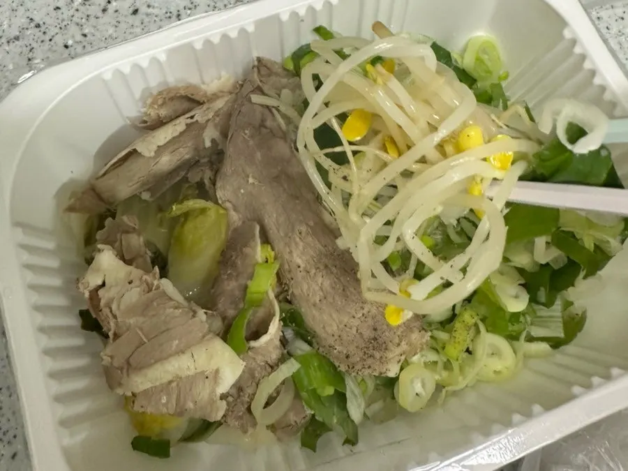 Takeout packs of glass noodles, kkakdugi, and seasoning paste