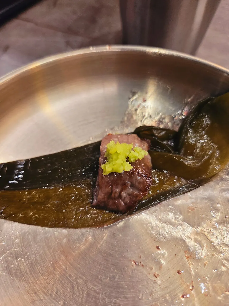 Hanwoo and foil-wrapped tteokgalbi grilling on the charcoal fire