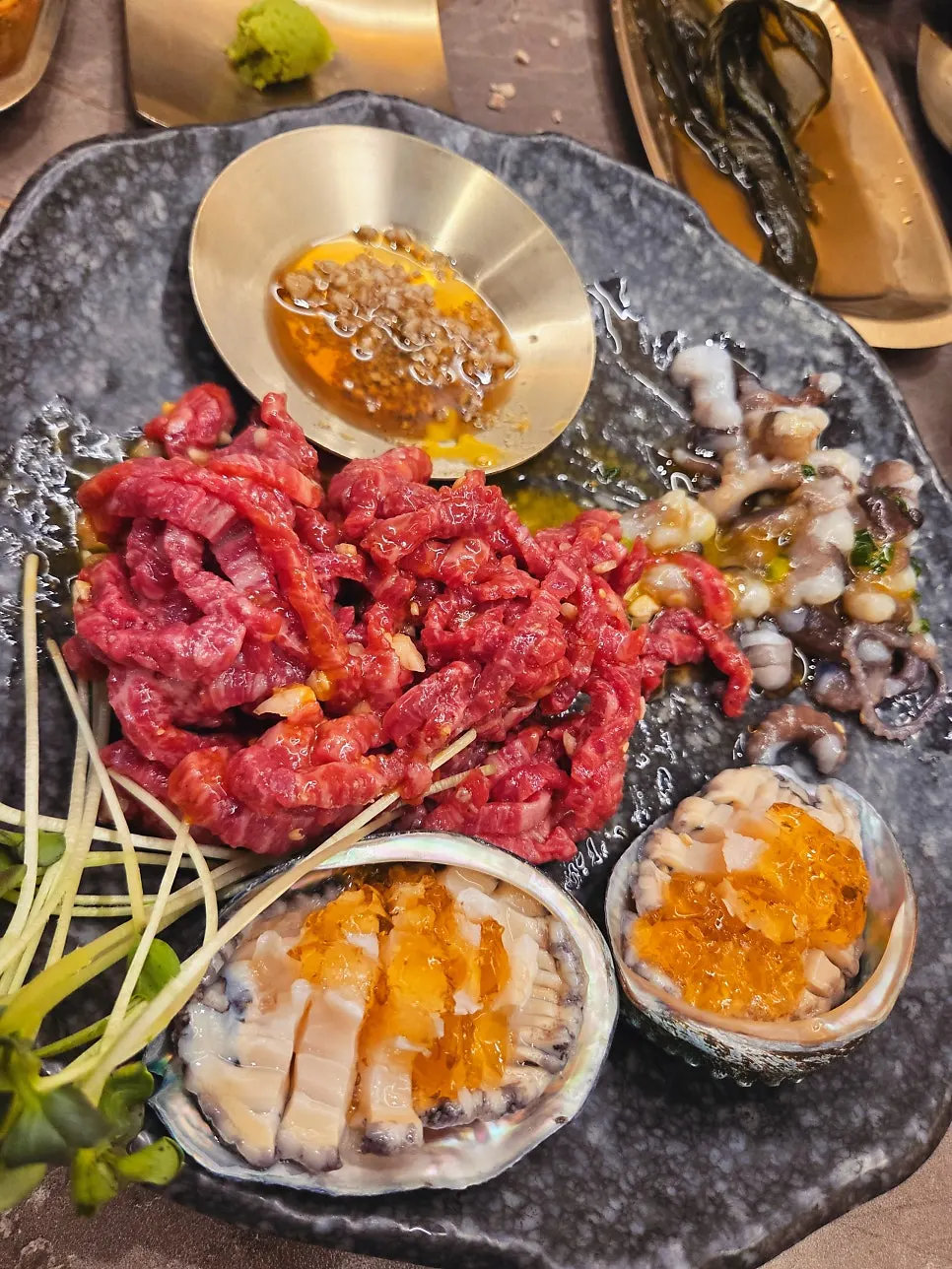 Yukhoe tangtang with beef tartare, octopus, and abalone sashimi