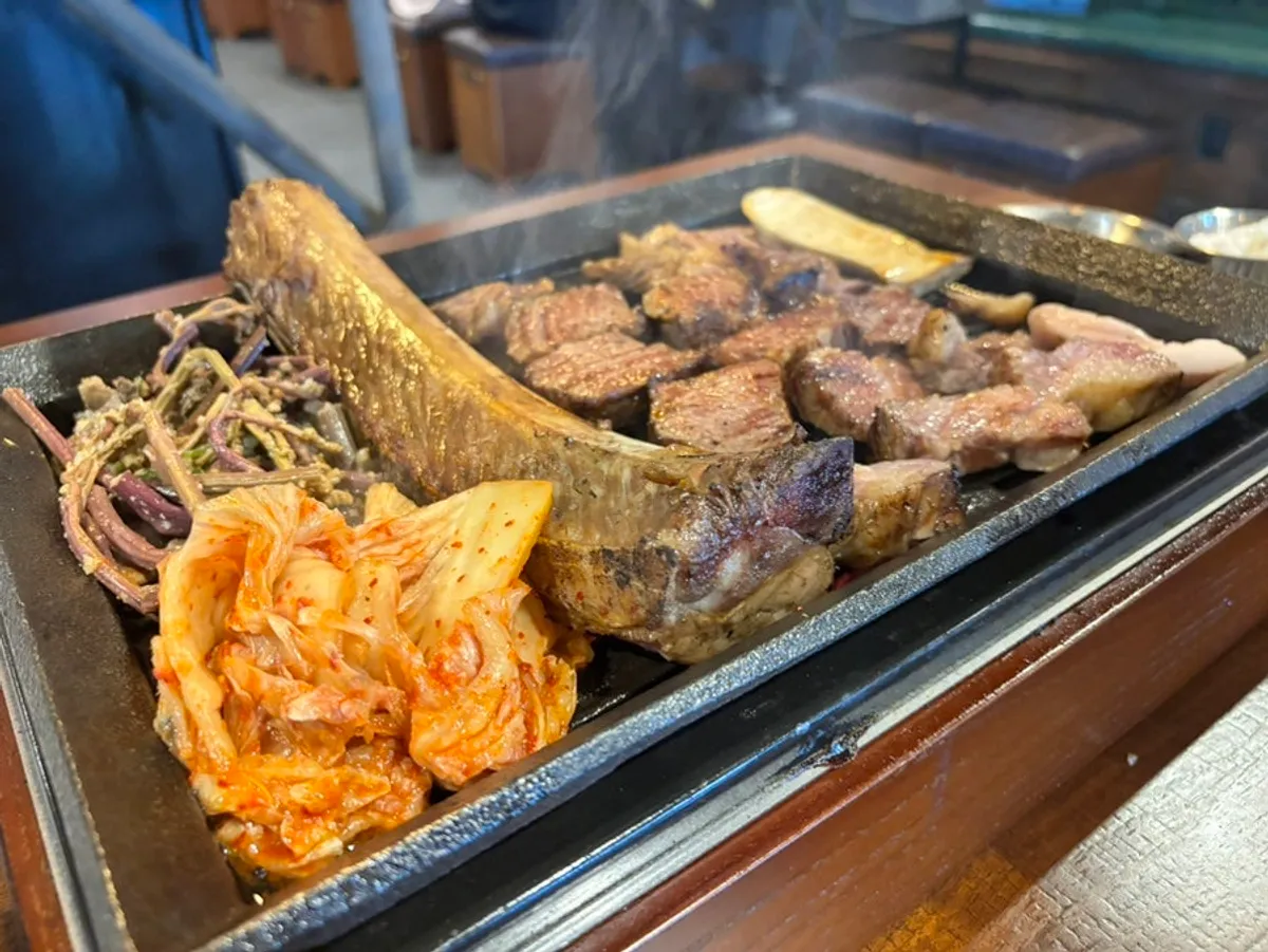 Two servings of marinated prime rib on the grill at Jipbul Taebaek