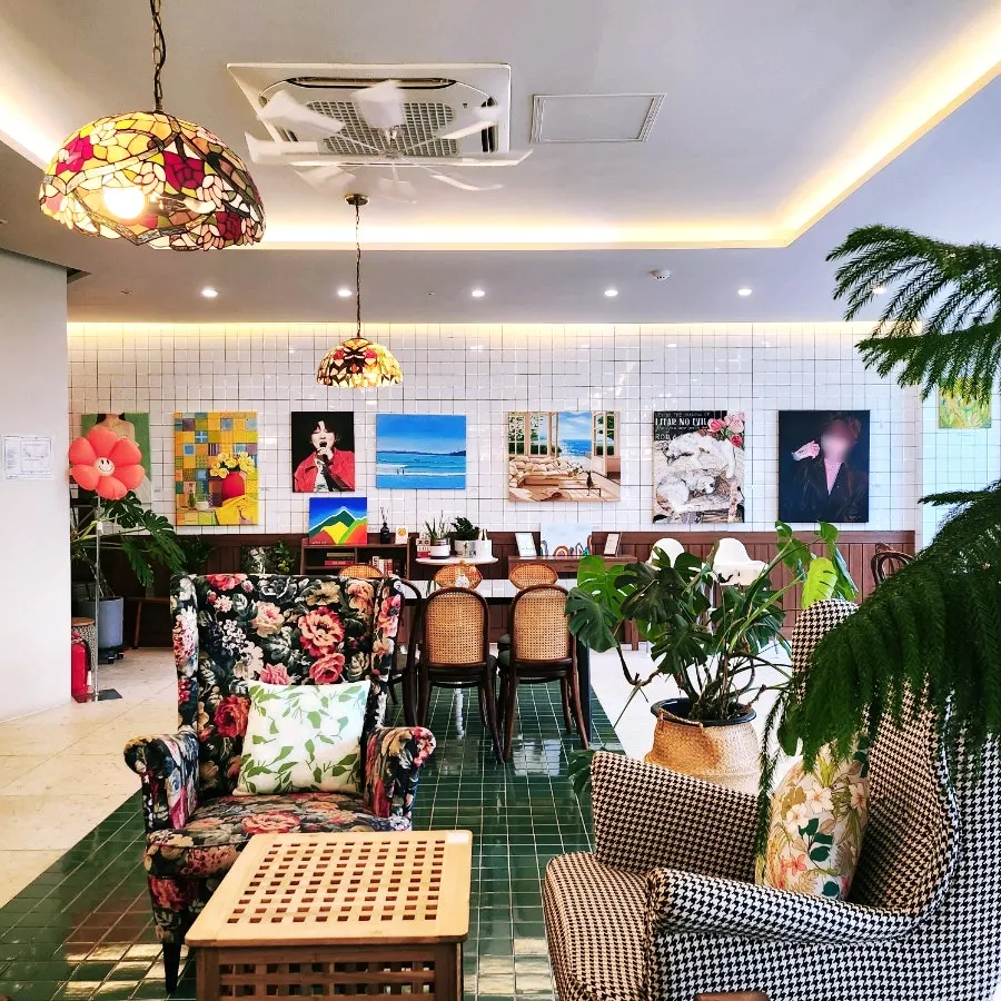 Wall display of paintings inside Café Meomureum