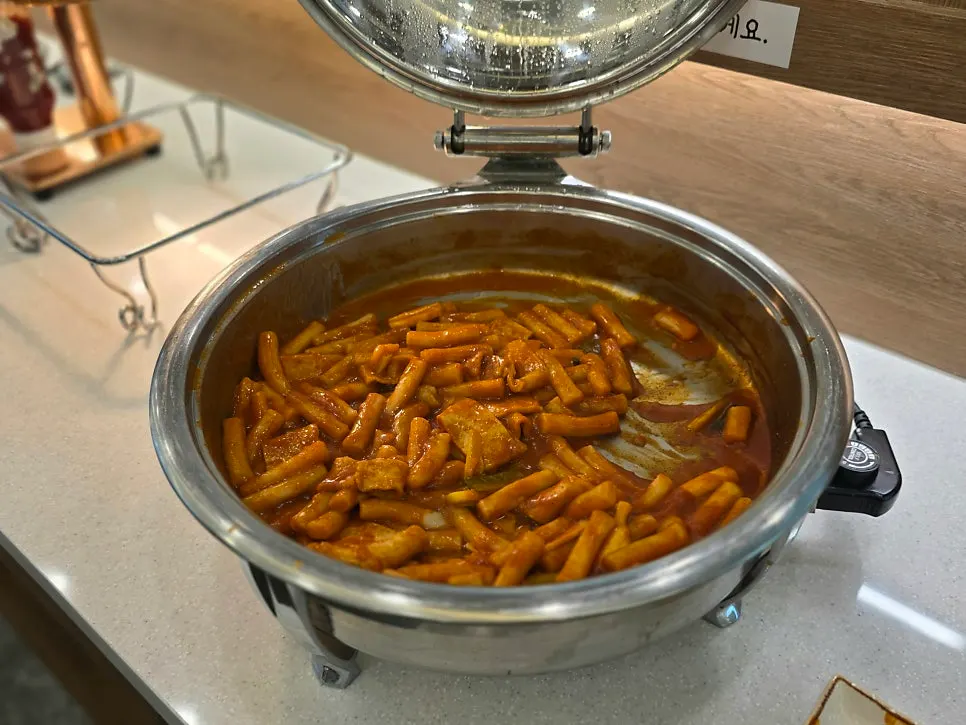 Tteokbokki, pumpkin jeon, and sausage jeon at the self-serve corner