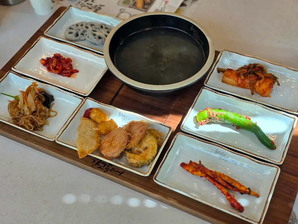 Basic table setting with kimchi, lotus root, and salted seafood