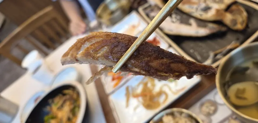 Plate of picked-apart mackerel flesh