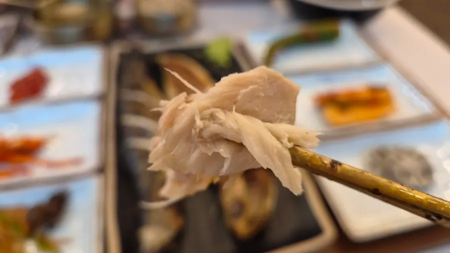A crispy-outside, moist-inside bite of grilled mackerel
