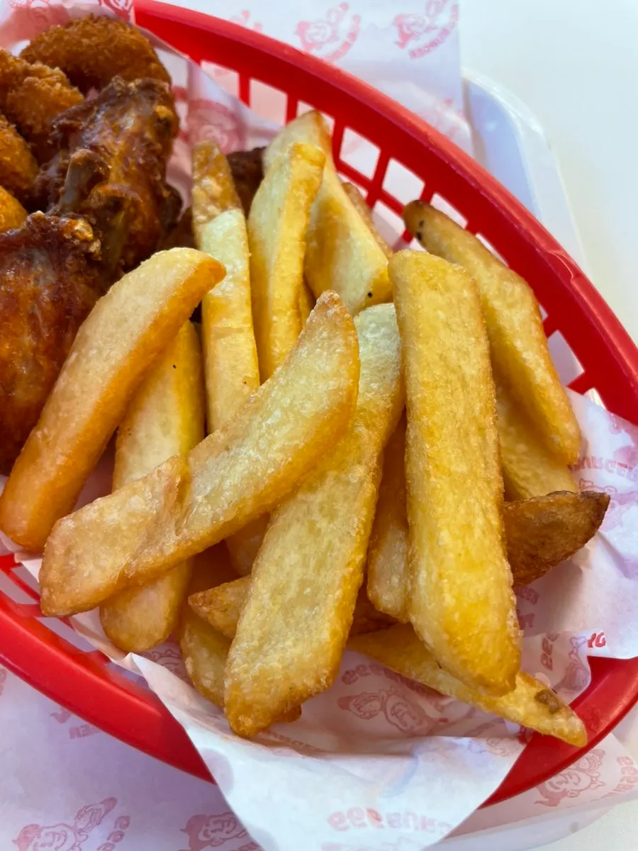 Garlic Boom burger and fries on a tray