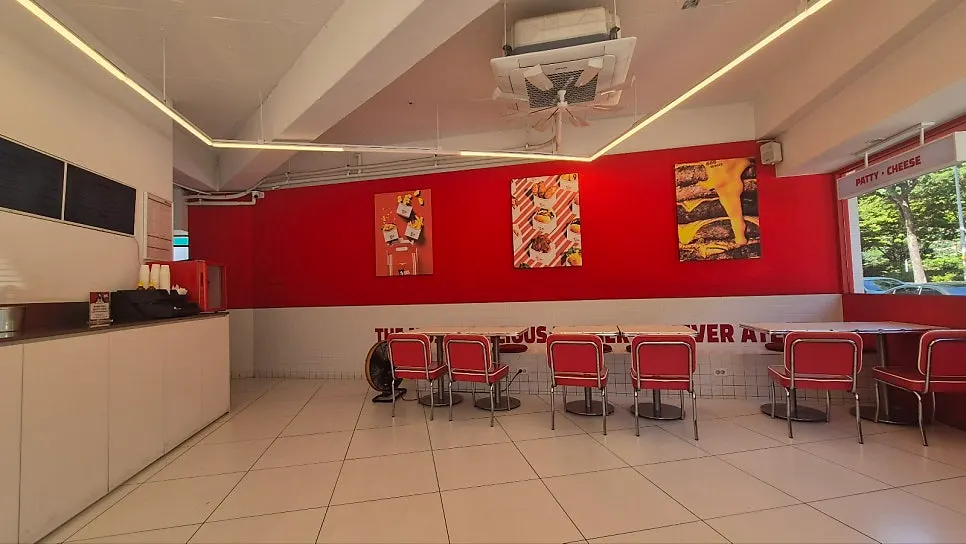 Red-toned interior of 666 Burger Main Branch
