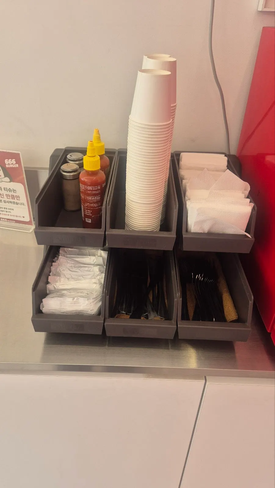 Ketchup, utensils, and wet wipes on the self-service bar