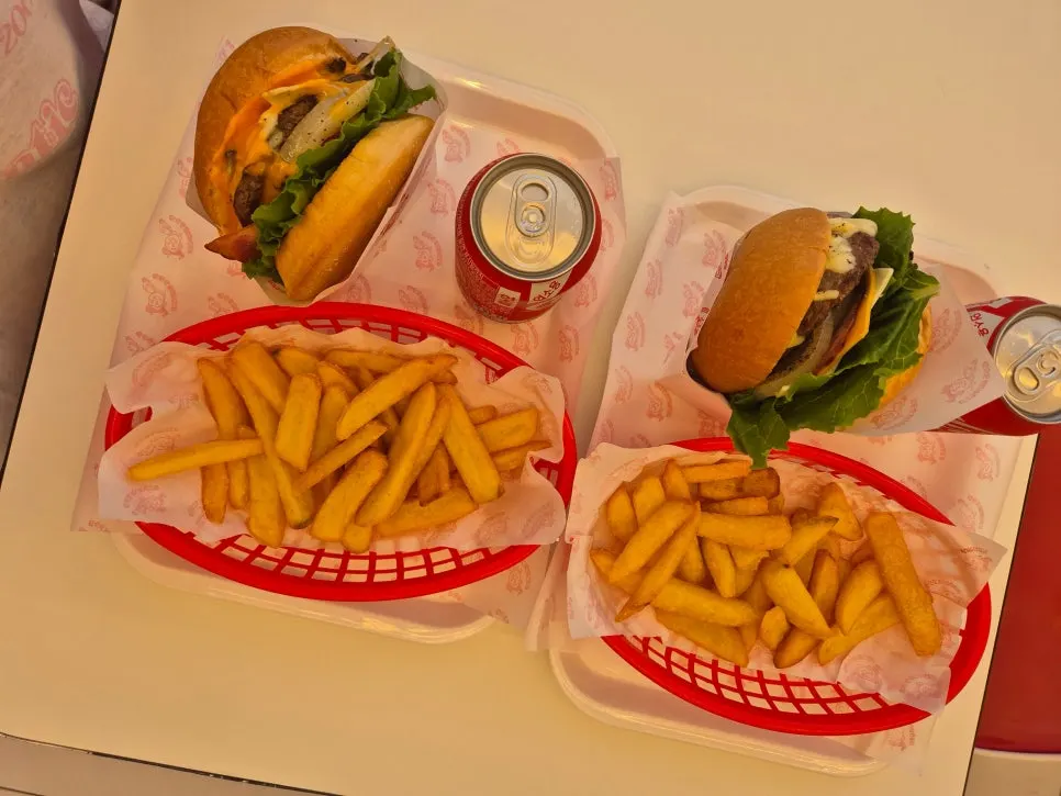 A set with burger, fries, and canned cola
