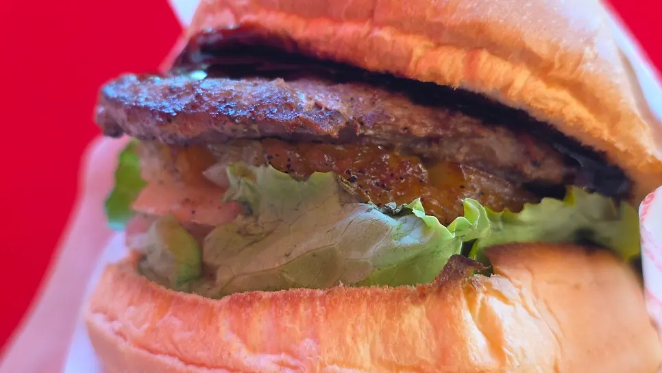 Smoky patty and pineapple visible in the burger
