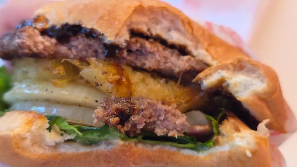 A bite taken out of the Grilled Hawaii Burger