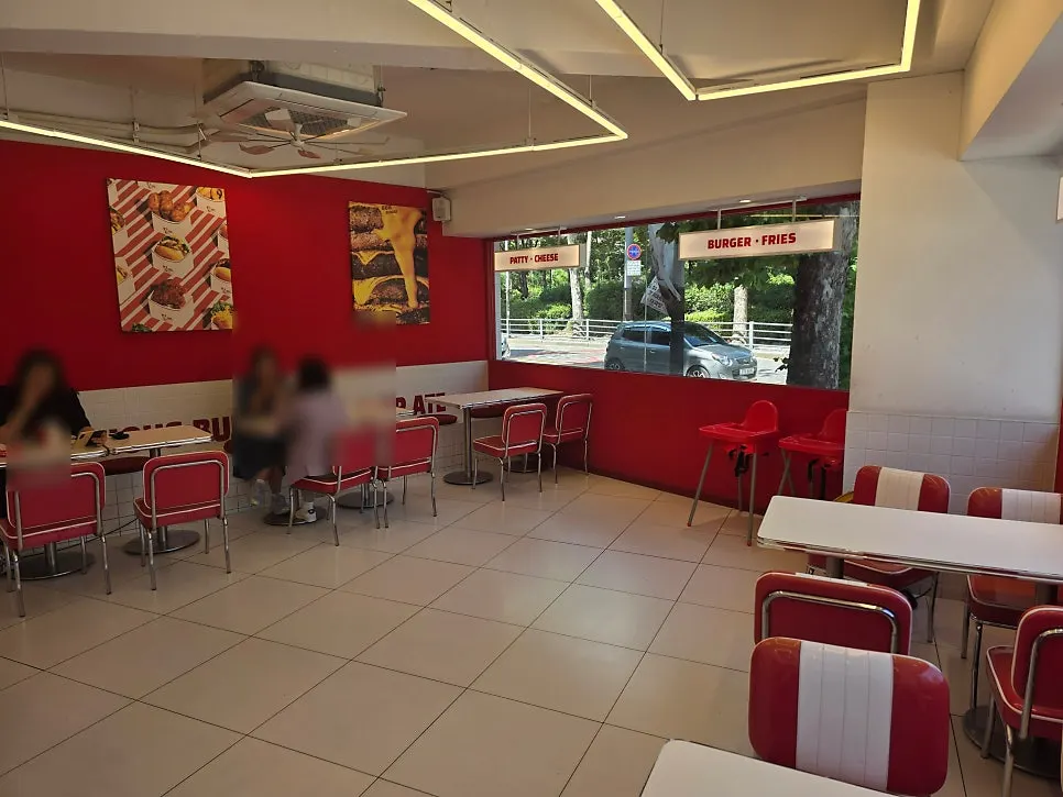 Floor-to-ceiling windows and red-and-white interior