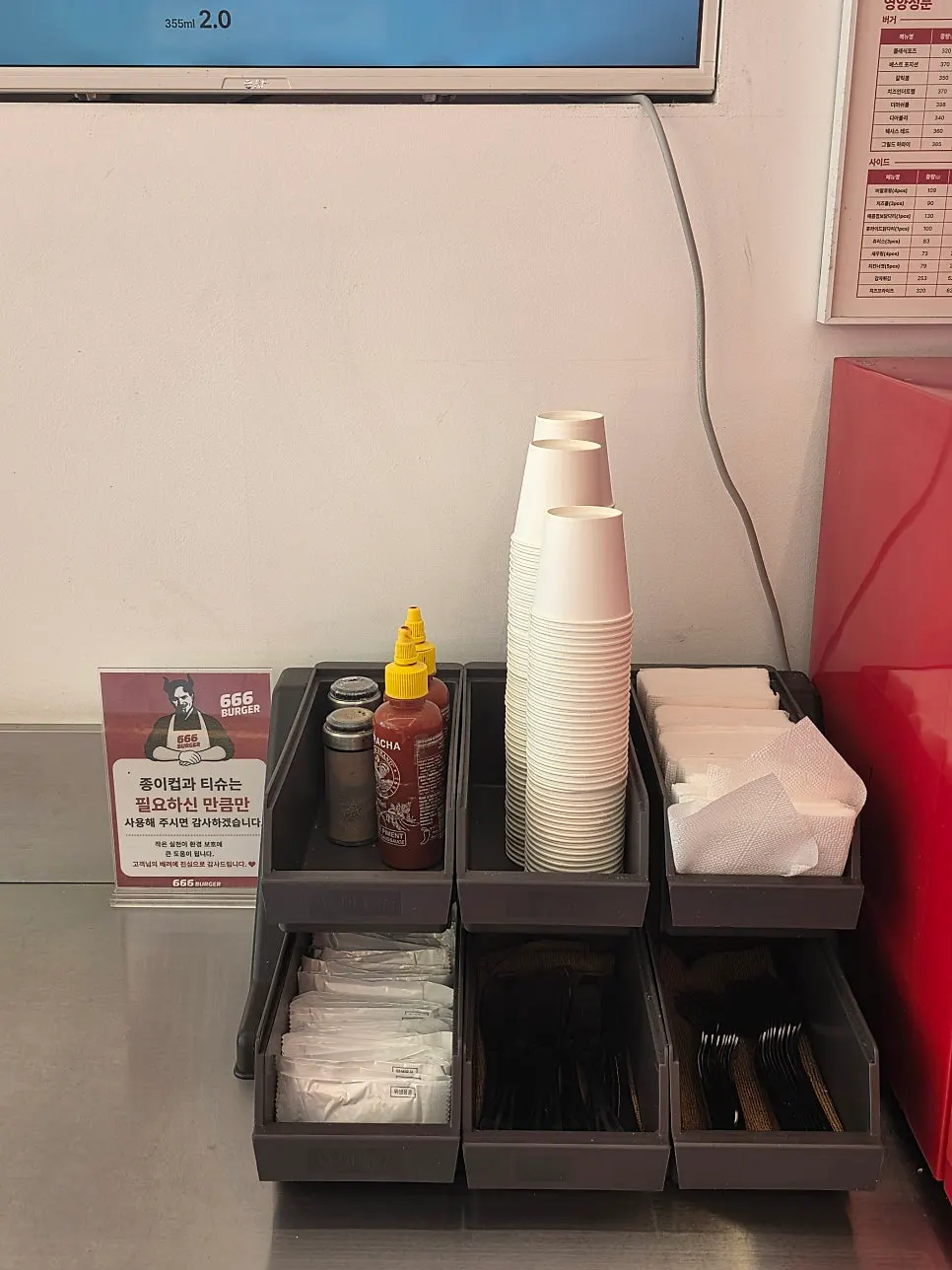 Self-service corner with hot sauce and wet wipes neatly arranged