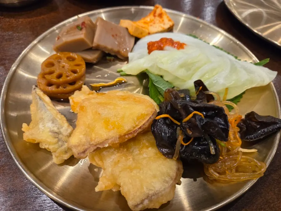 A plate of namul and side dishes gathered from the self-serve bar
