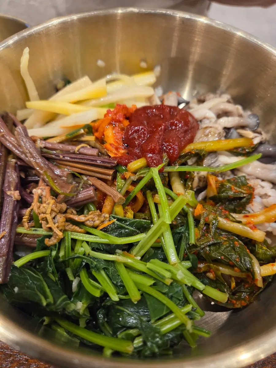 Barley bibimbap with sesame oil and gochujang added