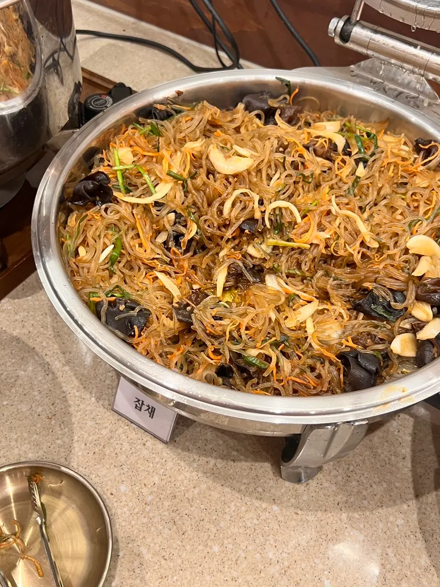 Pickled vegetables and bibimbap namul laid out at the self-serve bar