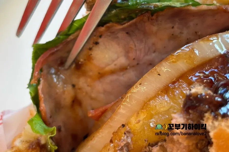 Side view of the paper-wrapped Grilled Hawaiian burger