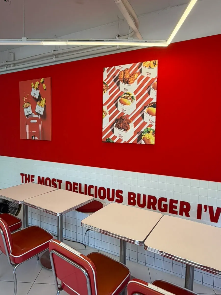 Poster of a burger with cheese oozing down