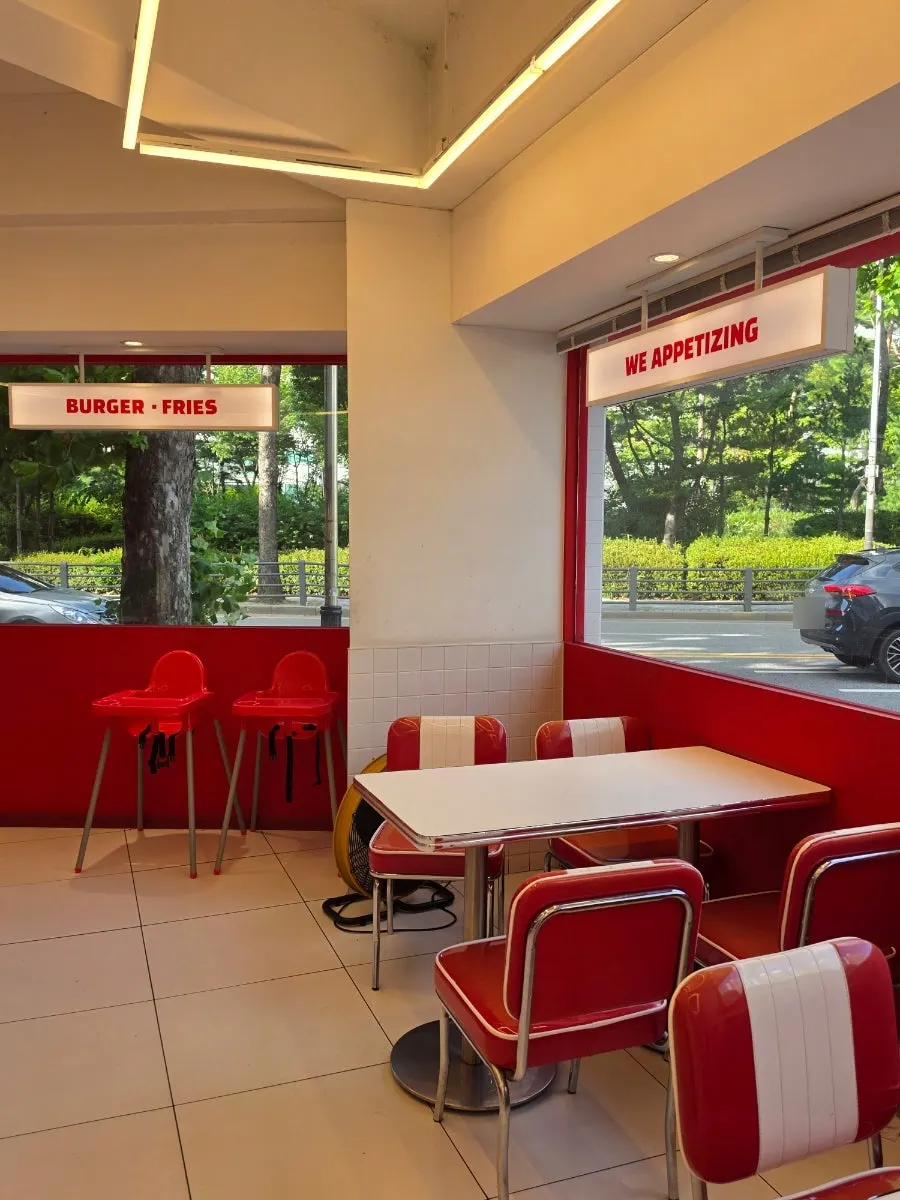 Interior seating with floor-to-ceiling windows at 666 Burger Main Branch