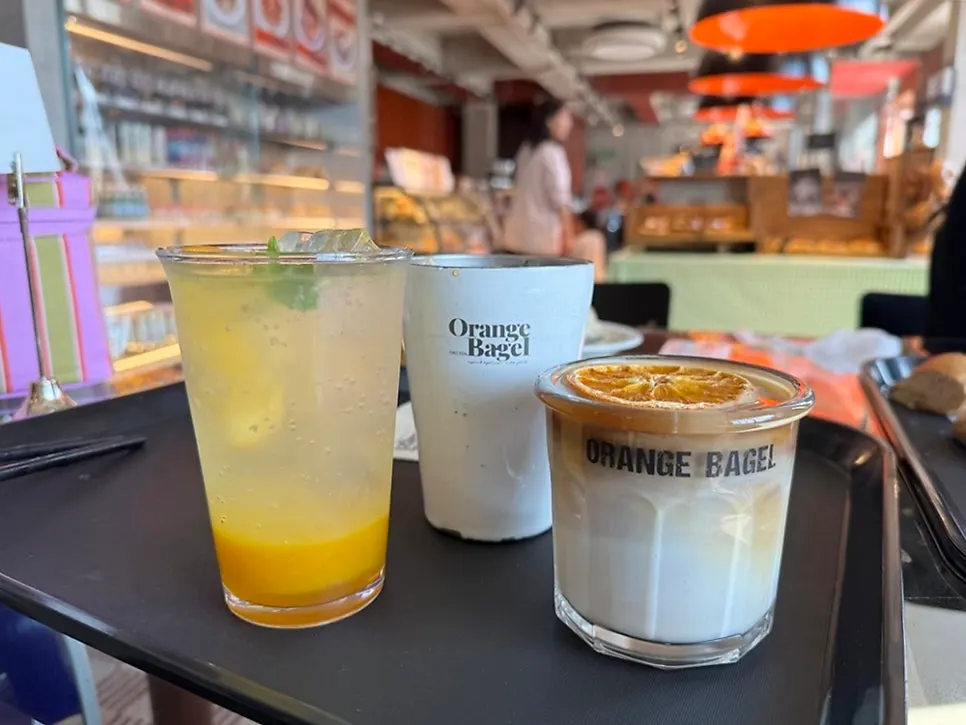 Orange ade, orange latte, and americano together