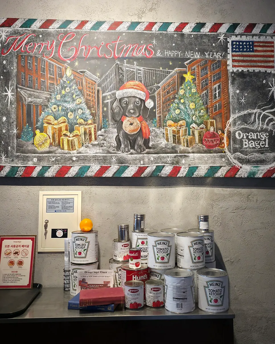 Oven for warming bagels with a mural beside it