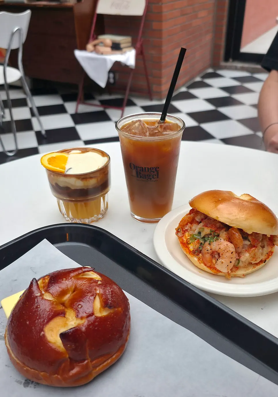 Table setting with two drinks and two bagels