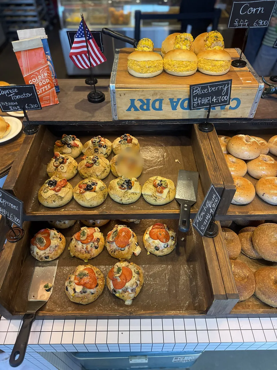 Bagels arranged by type on the display shelf