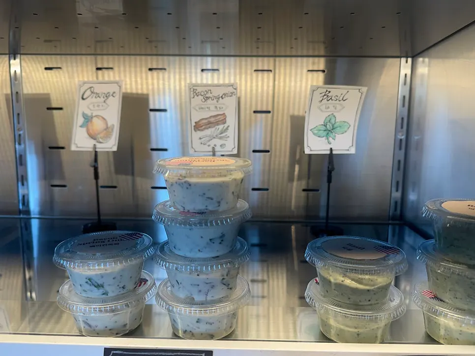 Various cream cheeses atop the refrigerated case