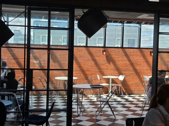 1st-floor seating with checkered tablecloths and a dachshund character