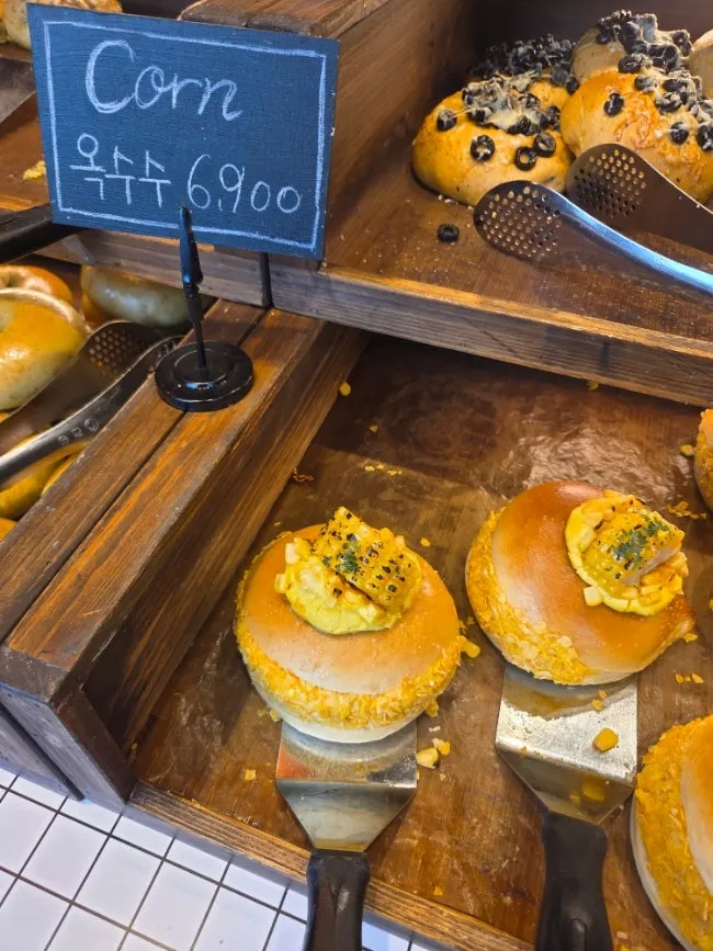 Orange americano and corn bagel on the table