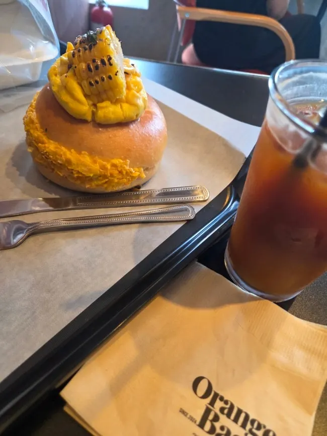 An iced orange americano with ice cubes