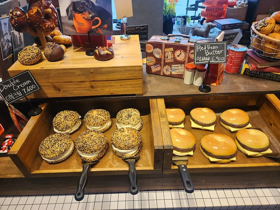 Display of bagels with various ingredients at Orange Bagel