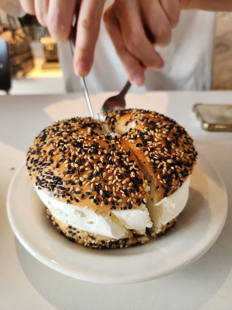 Cross-section of the double cream bagel topped with sesame seeds