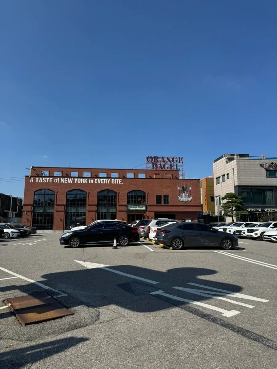 Red-brick exterior of the Orange Bagel building