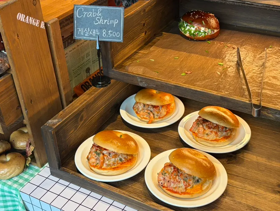 Olive tomato bagel on display at Orange Bagel