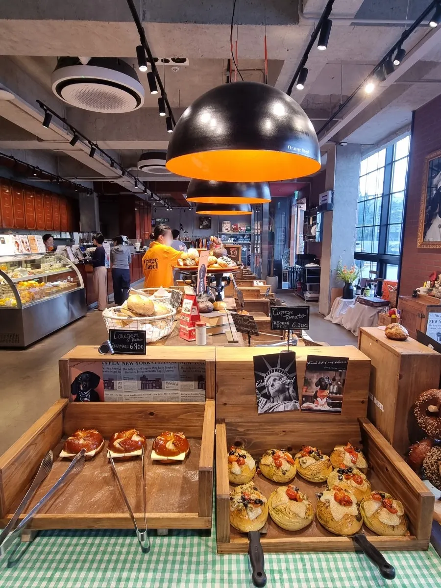 Menu board and bread display corner at Orange Bagel