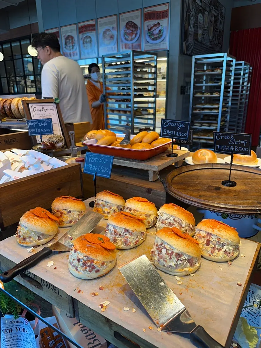 Choosing bagels at Orange Bagel