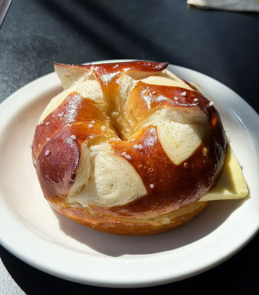 Cross-section of bacon egg mayo bagel in a sunlit seat