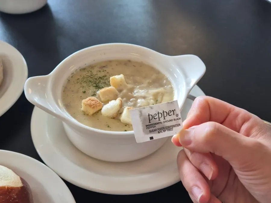 Warm soup served alongside the bagel