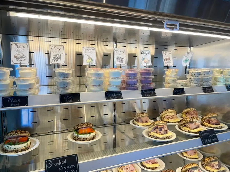 Freshly baked bagels being refilled on display