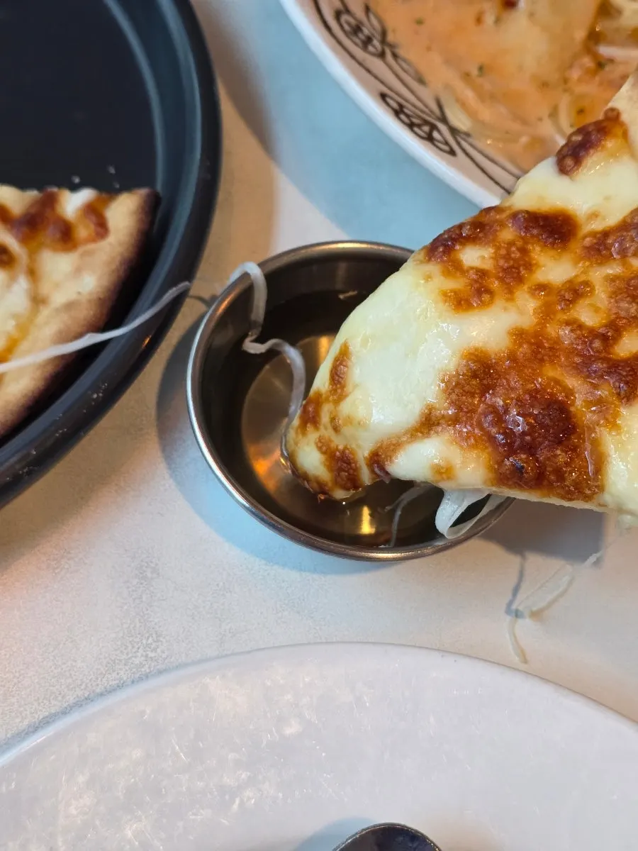 Cheesy gorgonzola pizza eaten with honey