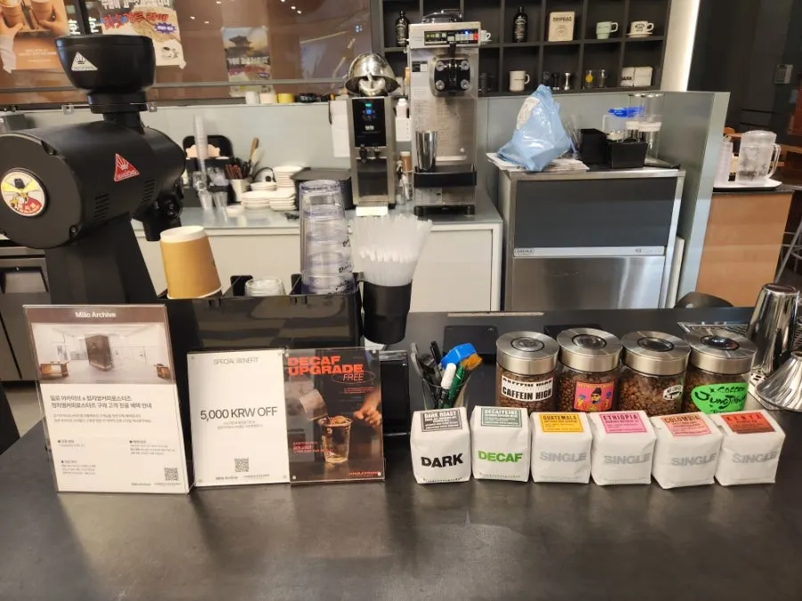 Display of goods including drip bags, keyrings, and cups